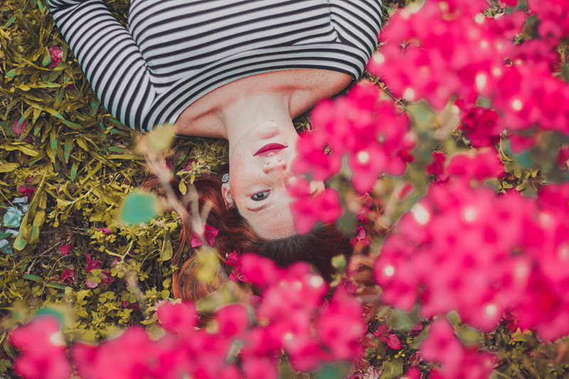 woman laying under flowers